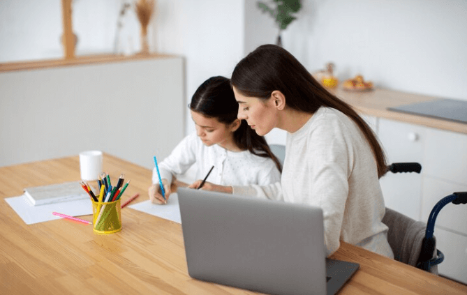 Mother assisting her young daughter with homework