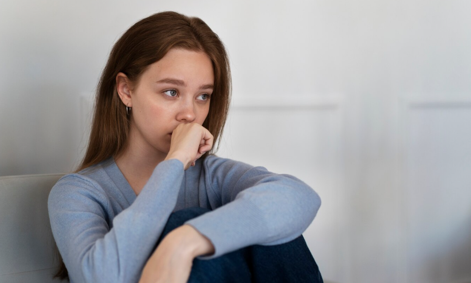 AFL - worried woman sitting on couch