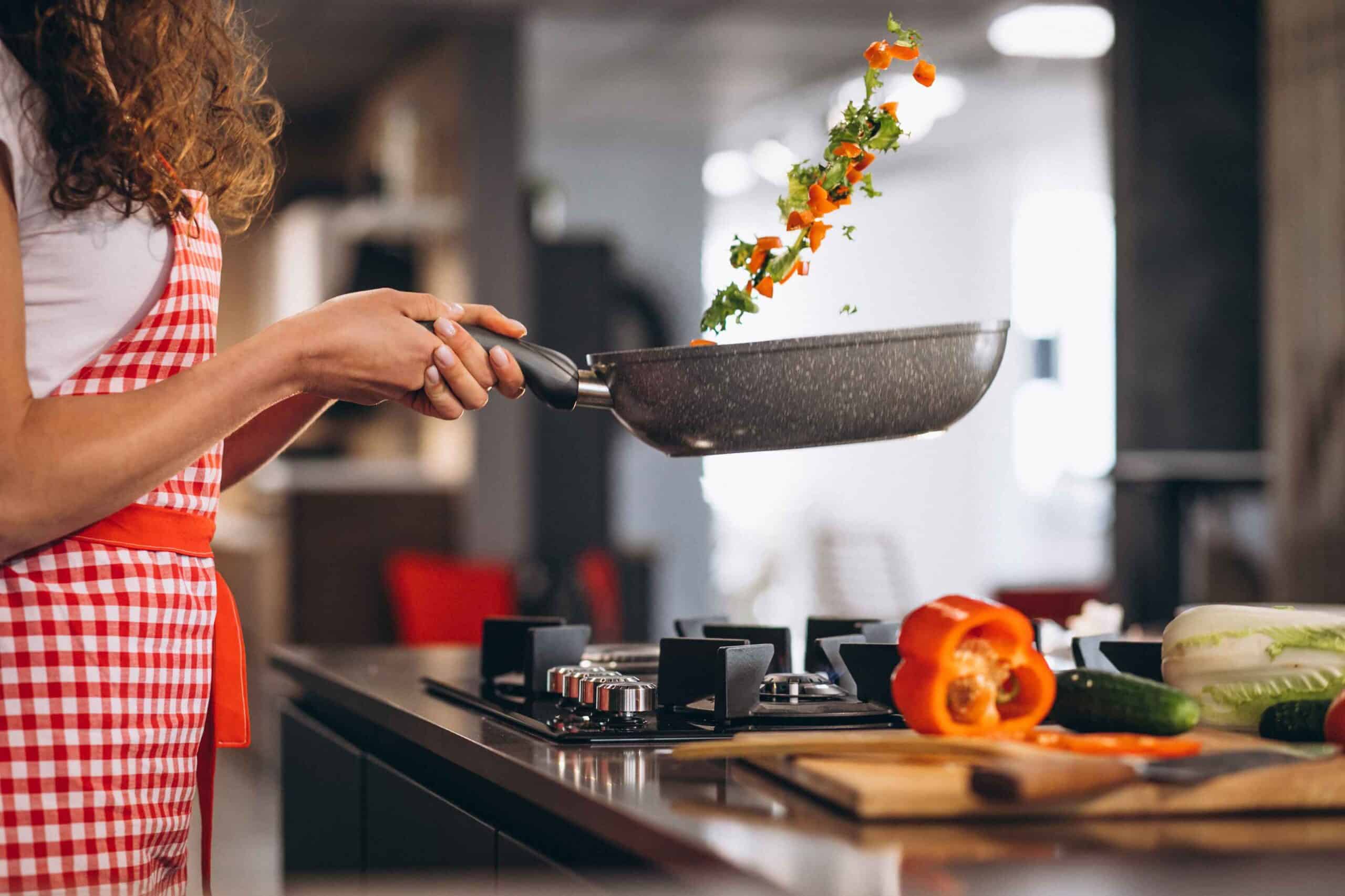 woman-chef-cooking-vegetables-pan 