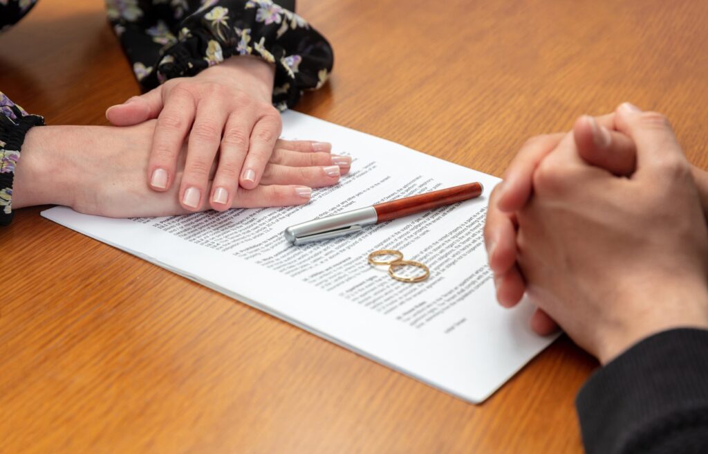 Divorce signature, marriage dissolution document. Wedding ring and agreement on lawyer office table family lawyers brisbane Trusted family lawyers