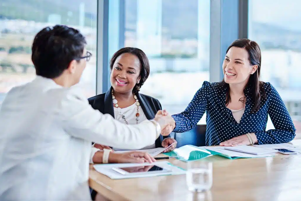Three women in a business meeting.