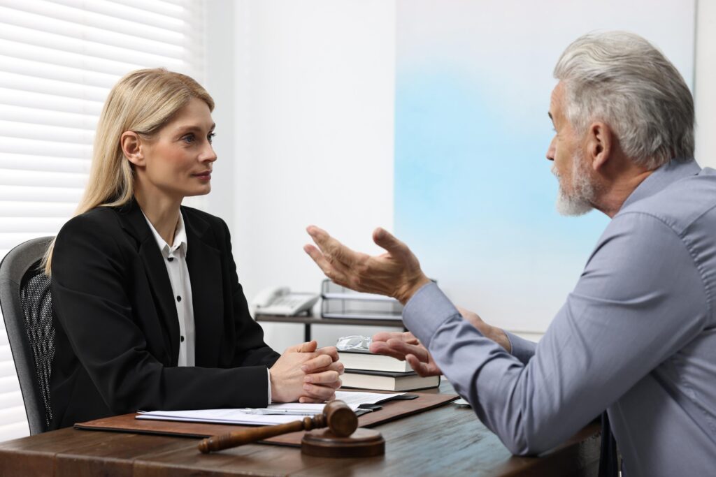Senior man having meeting with lawyer in office