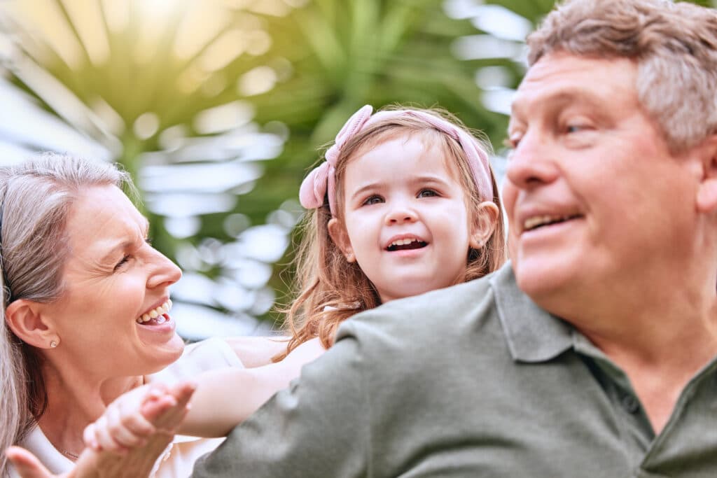 Summer, fun and grandparents with girl in the park enjoying weekend, holiday and quality time. Fami.