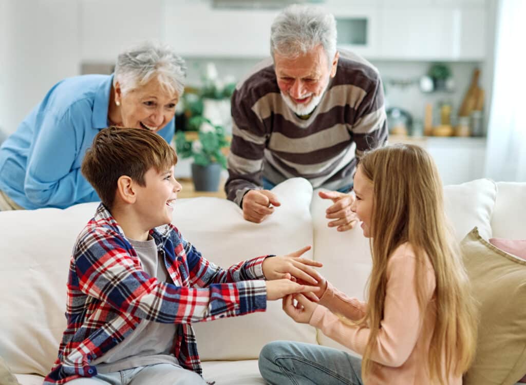 grandchild family child grandparent grandfather grandmother game playing hand hands leisure entertainment fun childhood joy enjoyment play laughing