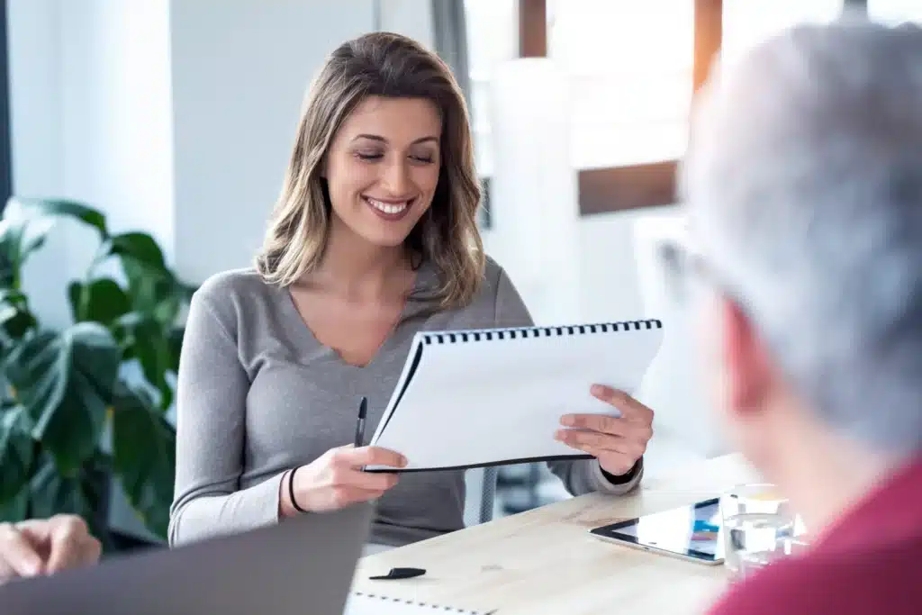 Smiling-woman-reviewing-her-notes-for-asset-protection-scaled.jpg